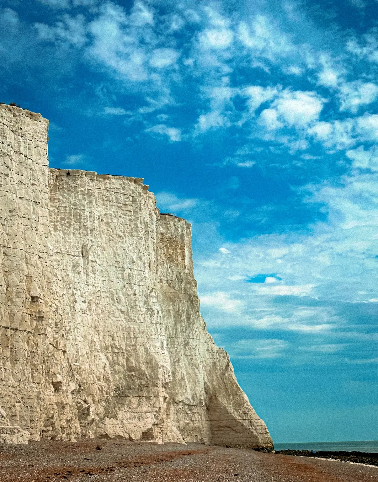 White chalk cliffs below a dramatic blue sky